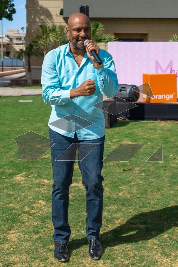 A person singing at a Christmas celebration in a garden during the day