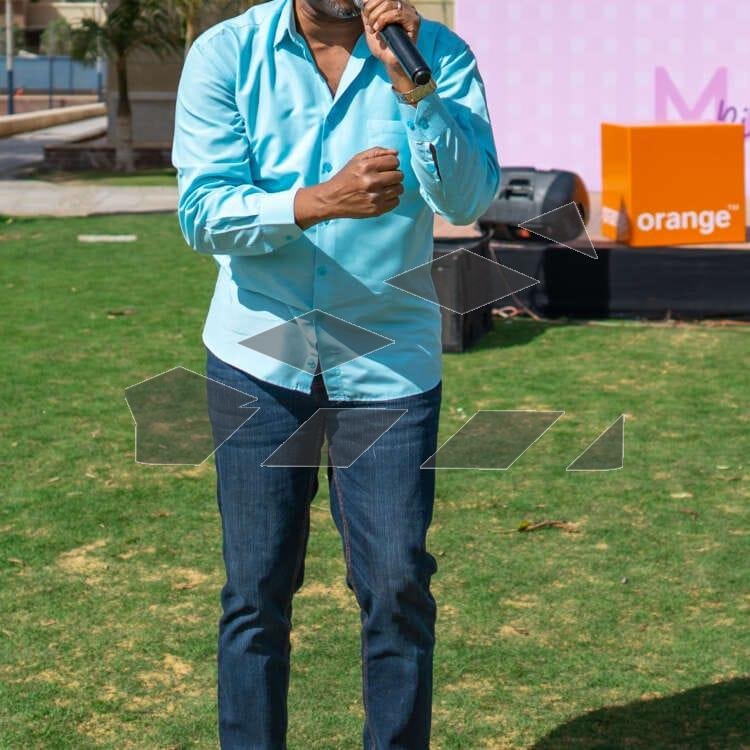 A person singing at a Christmas celebration in a garden during the day