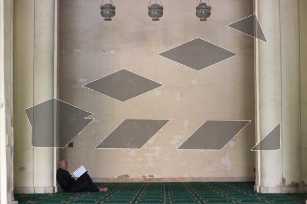 A man reads the Qur’an inside the historic Al-Hakim Mosque in Cairo.