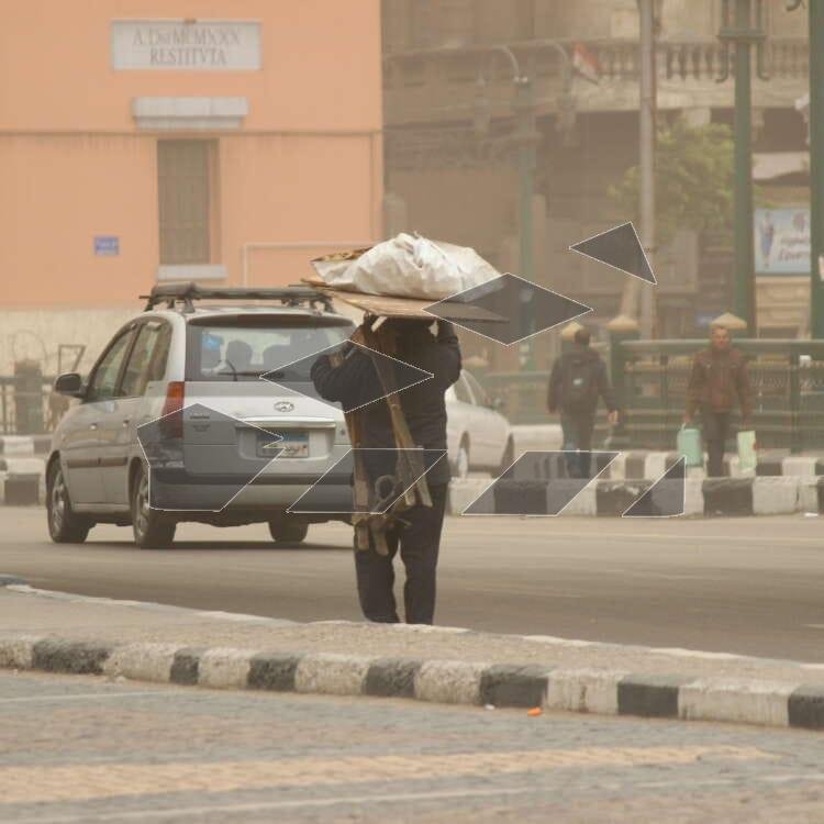A man carrying his tools in Abdel Moneim Riad Square, Cairo