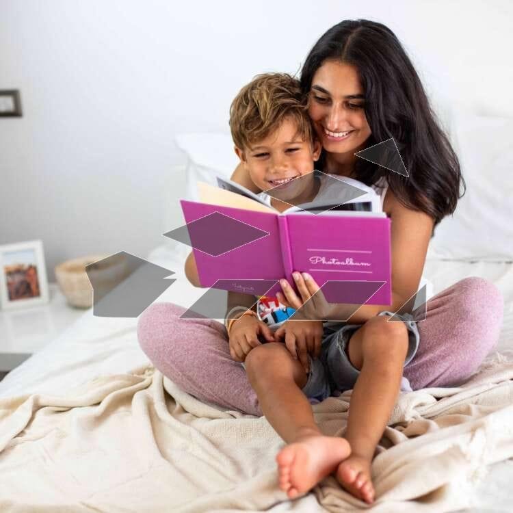 A girl is happily reading a book to her little brother