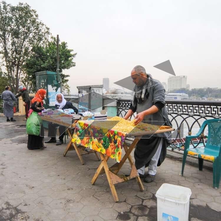 A street vendor prepares and serves Termis