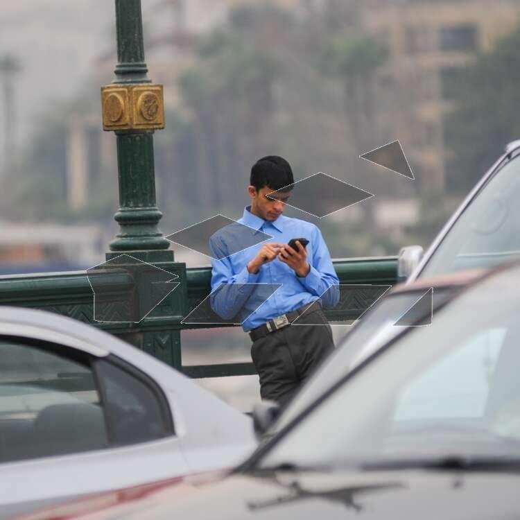 A man stands on Qasr El Nil Bridge in Cairo.
