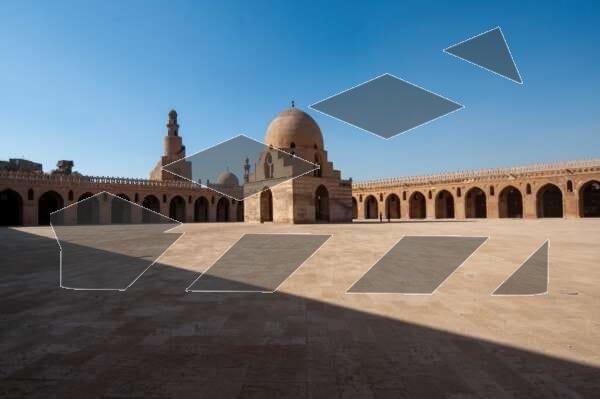 Architectural view of the central dome and spiral minaret of the historic Ahmad Ibn Tulun Mosque in Old Cairo, Egypt. The image captures the grandeur and symmetry of one of the oldest and most iconic Islamic structures in Egypt, showcasing its distinctive Samarran architectural style. Ideal for editorial use on Islamic architecture, heritage tourism, and historical landmarks.