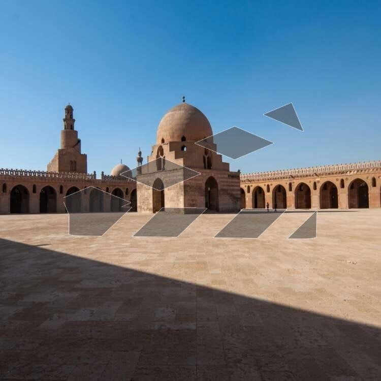 Architectural view of the central dome and spiral minaret of the historic Ahmad Ibn Tulun Mosque in Old Cairo, Egypt.