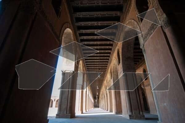 Interior view showcasing the architectural beauty of Ahmad Ibn Tulun Mosque in Old Cairo, Egypt.