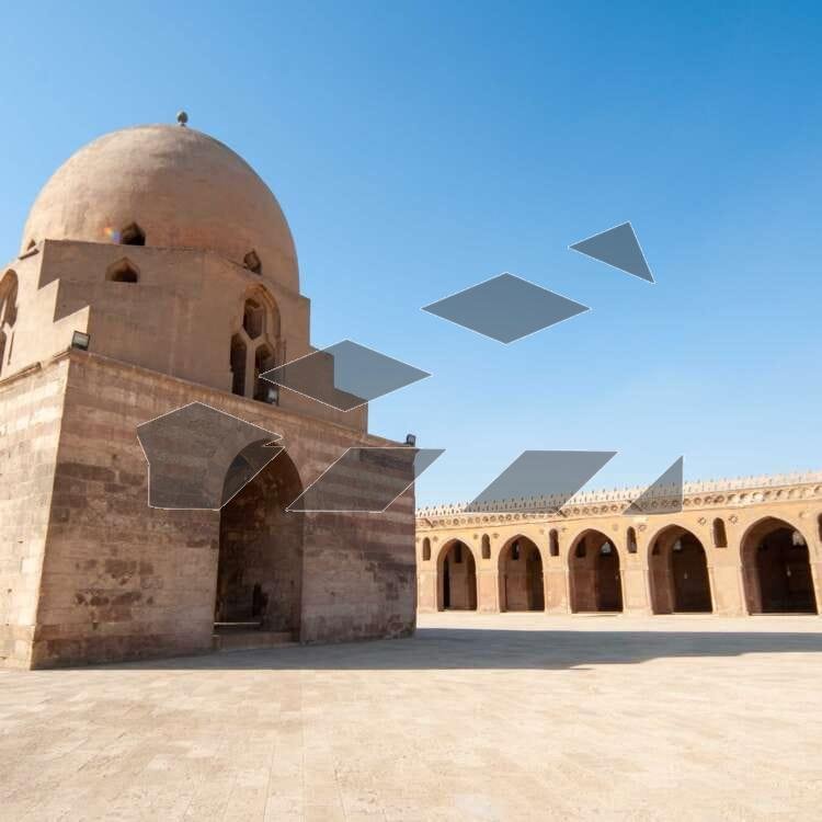 Architectural view of the central dome and spiral minaret of the historic Ahmad Ibn Tulun Mosque in Old Cairo, Egypt.