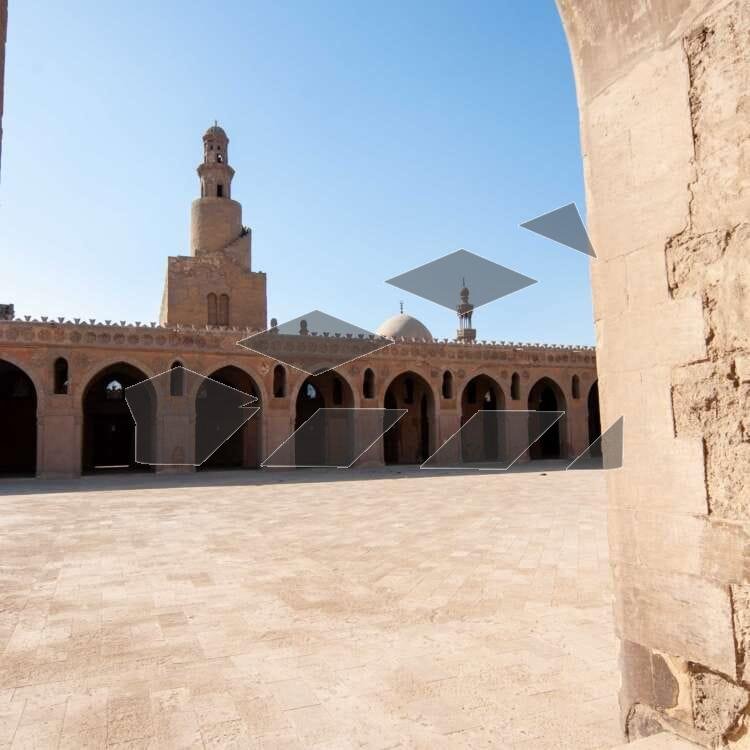 Architectural view of the central dome and spiral minaret of the historic Ahmad Ibn Tulun Mosque in Old Cairo, Egypt. The image captures the grandeur and symmetry of one of the oldest and most iconic Islamic structures in Egypt, showcasing its distinctive Samarran architectural style. Ideal for editorial use on Islamic architecture, heritage tourism, and historical landmarks.