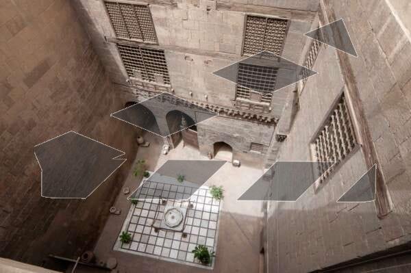 Outdoor courtyard at the Gayer-Anderson Museum in Old Cairo, Egypt, featuring a traditional display of pottery and brassware.