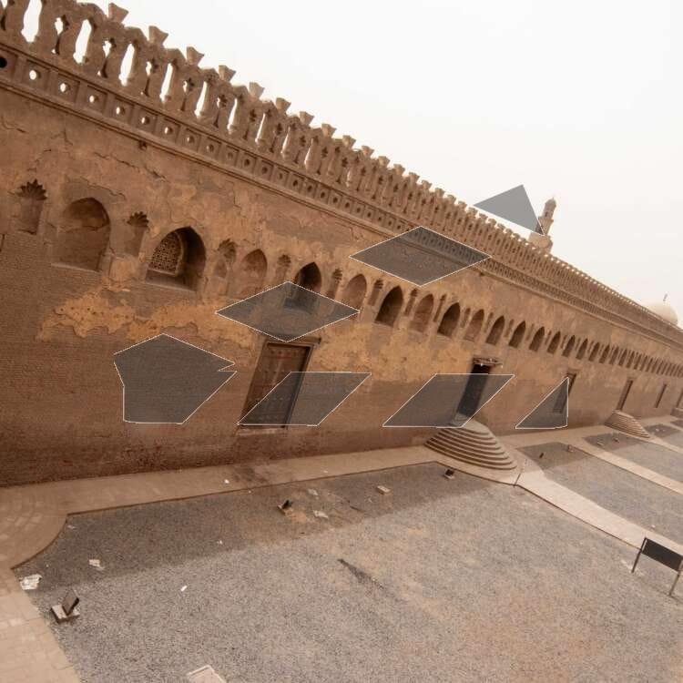 Architectural view of the central dome and spiral minaret of the historic Ahmad Ibn Tulun Mosque in Old Cairo, Egypt.