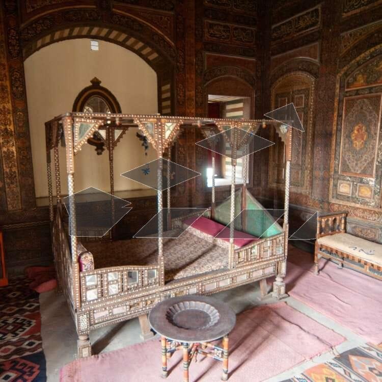 Antique wooden canopy bed displayed inside the Gayer-Anderson Museum in Old Cairo, Egypt.