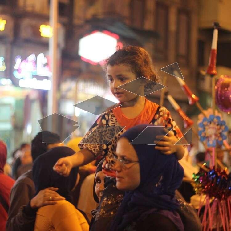 Women Carrying Children on Their Shoulders During Festive Mawlid Celebration – Cairo, Egypt