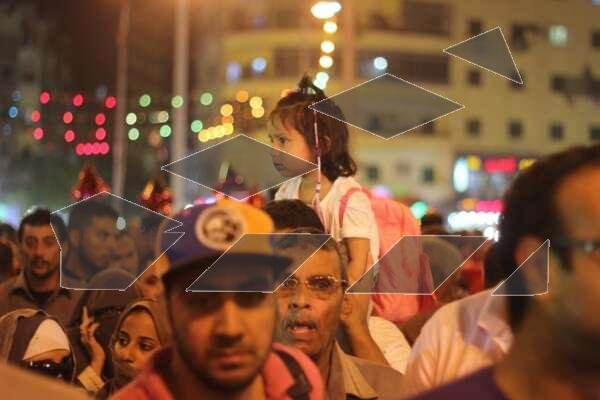 Women Carrying Children on Their Shoulders During Festive Mawlid Celebration – Cairo, Egypt