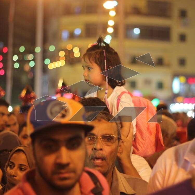 Women Carrying Children on Their Shoulders During Festive Mawlid Celebration – Cairo, Egypt