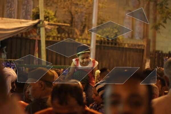 Women Carrying Children on Their Shoulders During Festive Mawlid Celebration – Cairo, Egypt