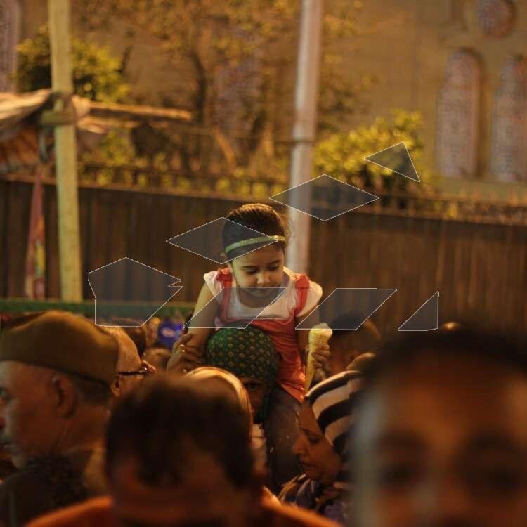 Women Carrying Children on Their Shoulders During Festive Mawlid Celebration – Cairo, Egypt