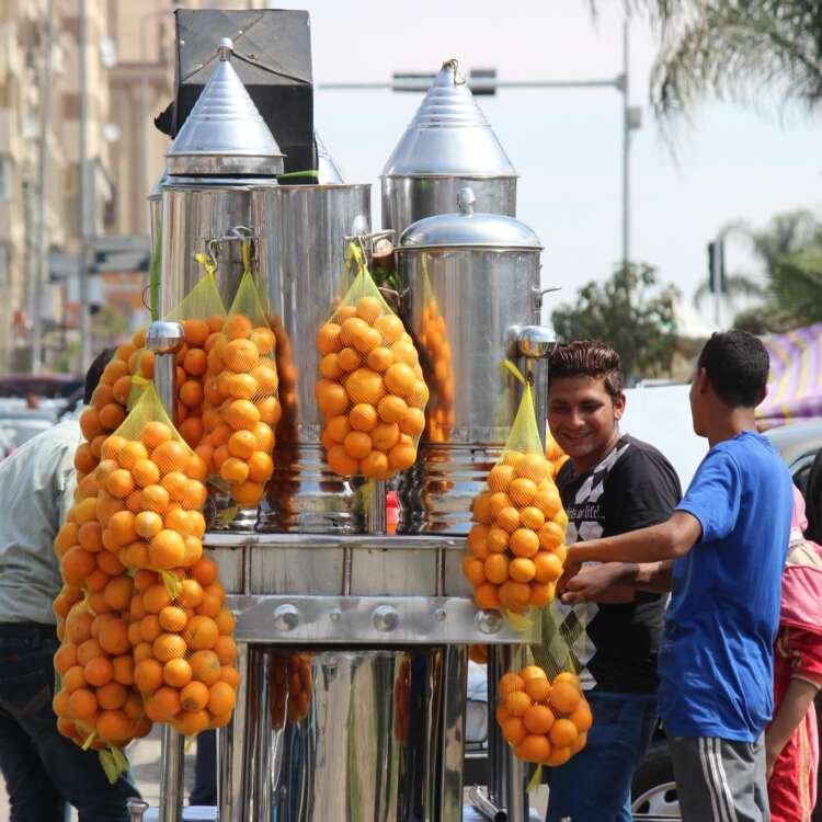 Fresh Orange Juice Cart at the Car Market in Nasr City – A Refreshing Cairo Street Scene