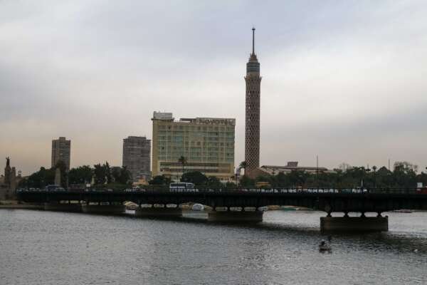 Nile River with Cairo Tower and Riverside Buildings on a Cloudy Day