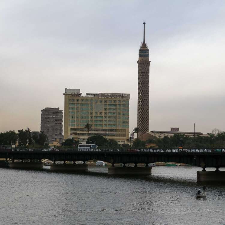 Nile River with Cairo Tower and Riverside Buildings on a Cloudy Day