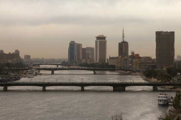Nile River with Cairo Tower and Riverside Buildings on a Cloudy Day