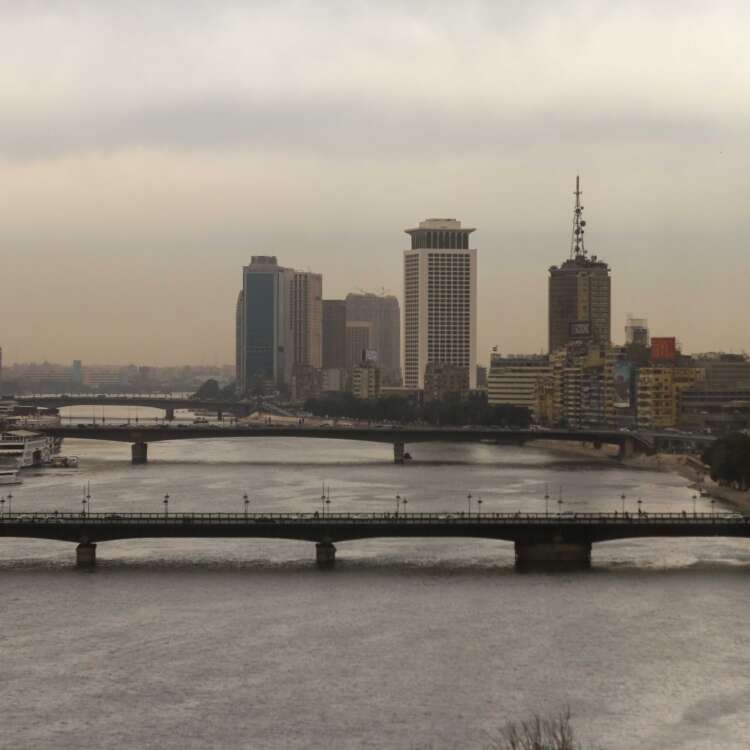 Nile River with Cairo Tower and Riverside Buildings on a Cloudy Day