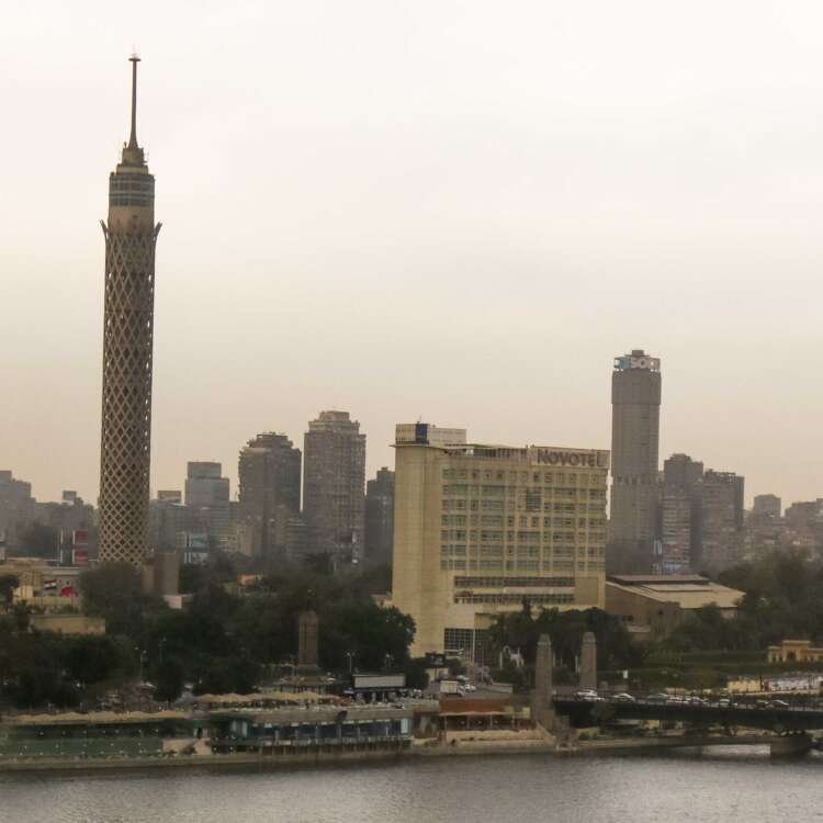 Fishing Boat on the Nile with Cloudy Sky and Cairo Skyline