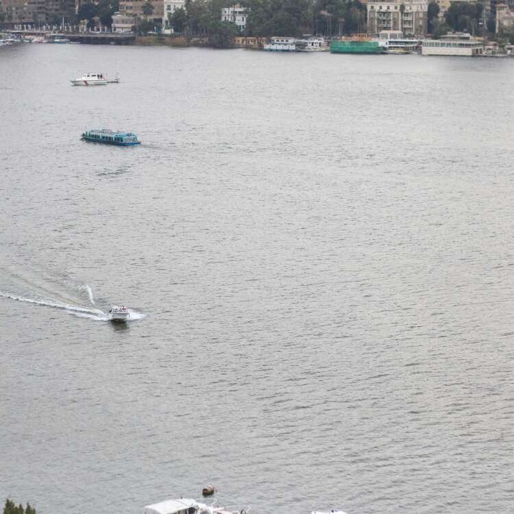 Fishing Boat on the Nile with Cloudy Sky and Cairo Skyline
