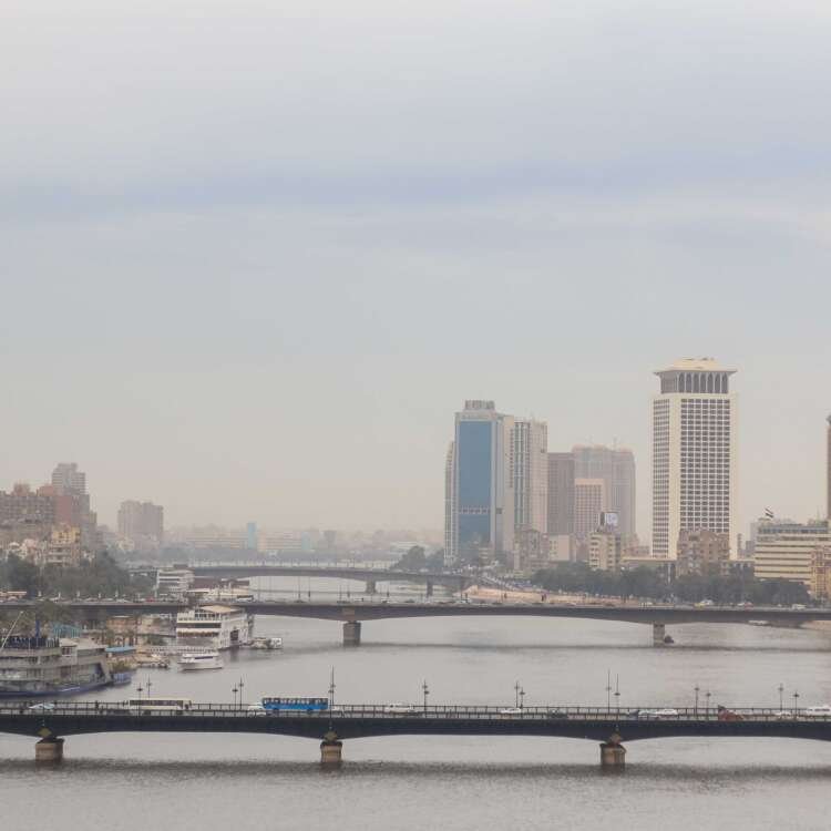 Nile River with Cairo Tower and Riverside Buildings on a Cloudy Day
