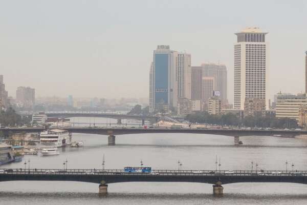 Nile River with Cairo Tower and Riverside Buildings on a Cloudy Day Nile River with Cairo Tower and Riverside Buildings on a Cloudy Day