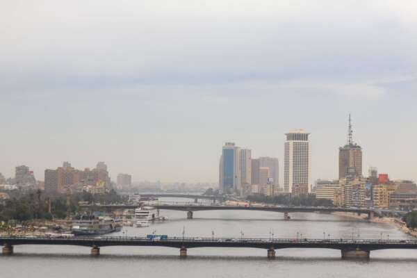 Nile River with Cairo Tower and Riverside Buildings on a Cloudy Day Nile River with Cairo Tower and Riverside Buildings on a Cloudy Day