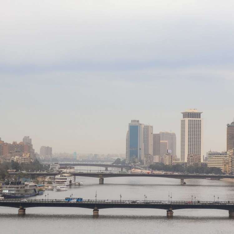 Nile River with Cairo Tower and Riverside Buildings on a Cloudy Day
