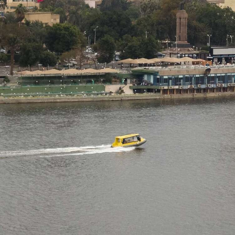 Boat on the Nile with Cloudy Sky, Cairo Skyline, and Cairo Tower