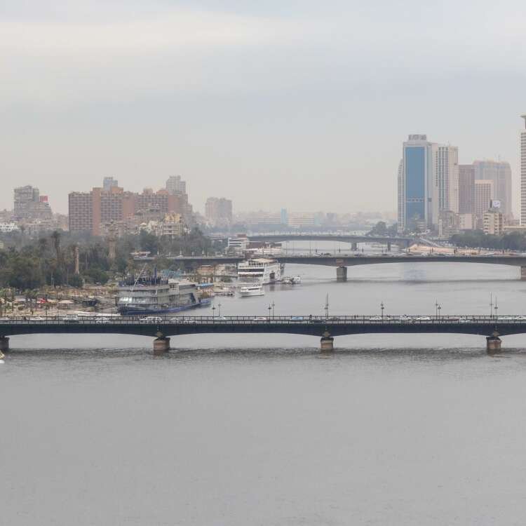 Nile River with Cairo Tower and Riverside Buildings on a Cloudy Day