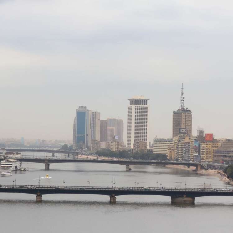 Nile River with Cairo Tower and Riverside Buildings on a Cloudy Day