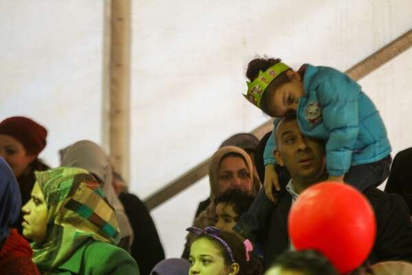 Father Carrying His Daughter to Watch Puppet Show at Cairo International Book Fair – 2017