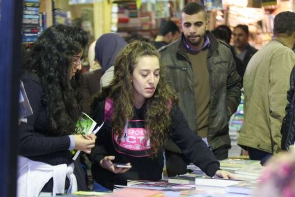 Two Girls Holding Their Books at Cairo International Book Fair – 2017