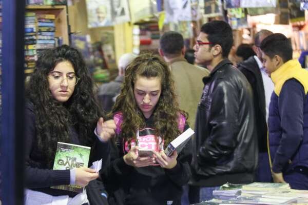 Two Girls Holding Their Books at Cairo International Book Fair – 2017