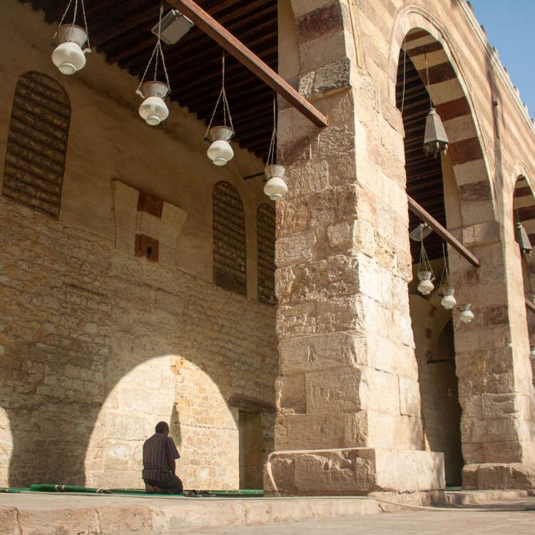 Wide Interior View of the Blue Mosque in Cairo with a Man Praying