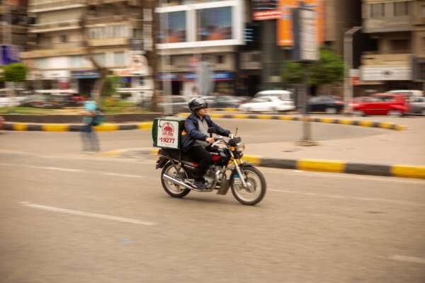 Motorcycle Delivery Rider in Cairo City Streets