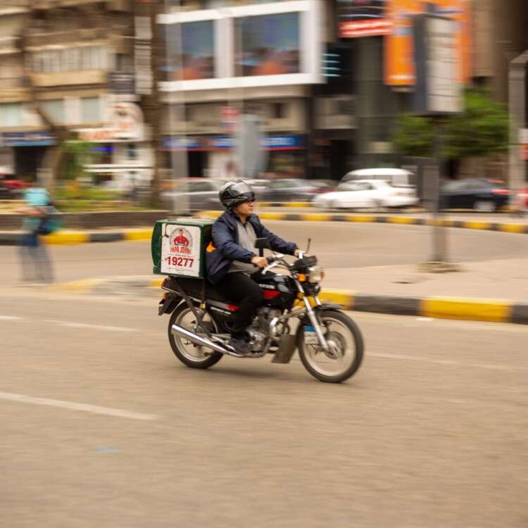 Motorcycle Delivery Rider in Cairo City Streets