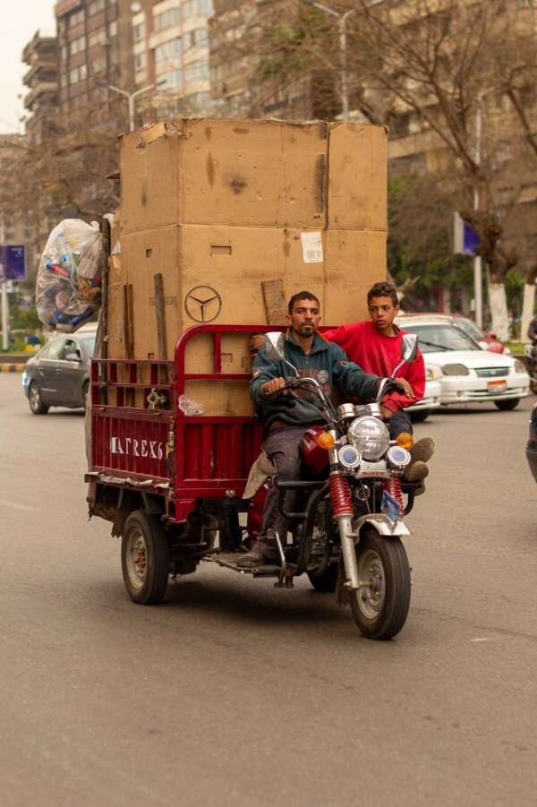 Men Transporting Cardboard Boxes on Motor Tricycle in Cairo