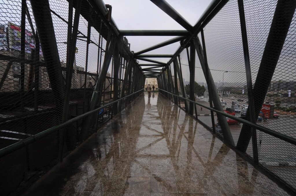 Rainy Pedestrian Bridge in Cairo with Reflections