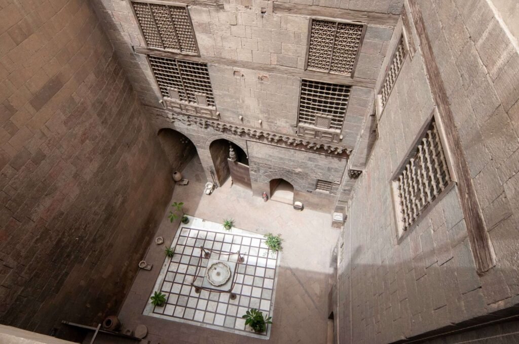Outdoor courtyard at the Gayer-Anderson Museum in Old Cairo, Egypt, featuring a traditional display of pottery and brassware.