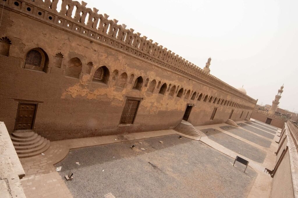 Architectural view of the central dome and spiral minaret of the historic Ahmad Ibn Tulun Mosque in Old Cairo, Egypt.