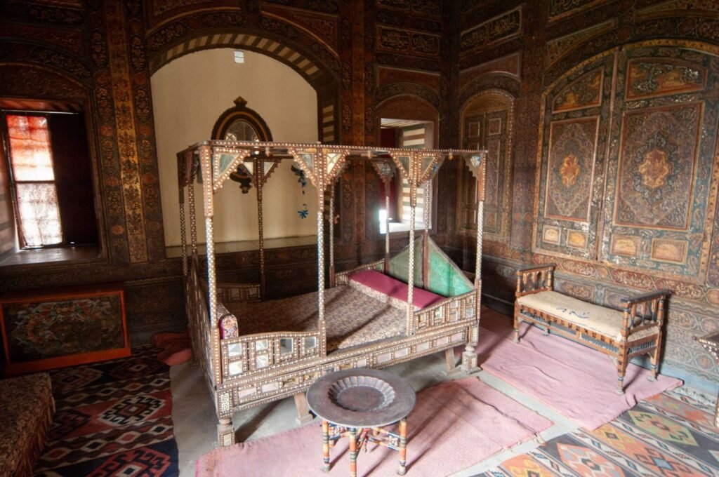 Antique wooden canopy bed displayed inside the Gayer-Anderson Museum in Old Cairo, Egypt.