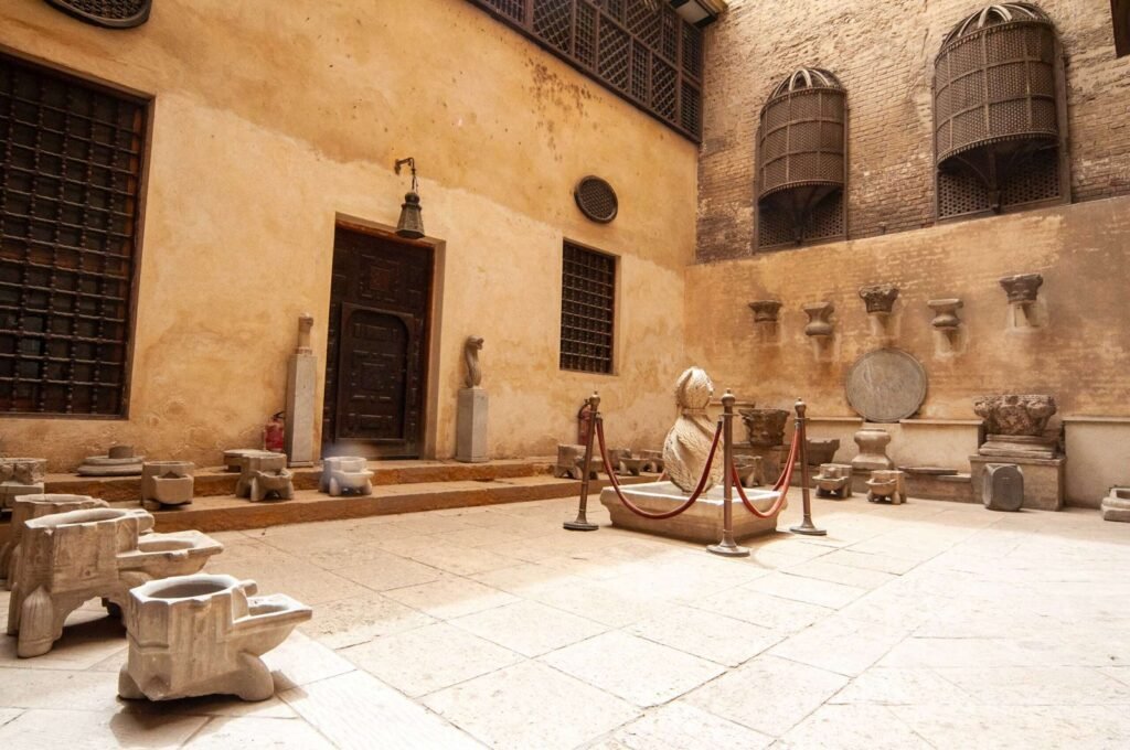 Outdoor courtyard at the Gayer-Anderson Museum in Old Cairo, Egypt, featuring a traditional display of pottery and brassware.