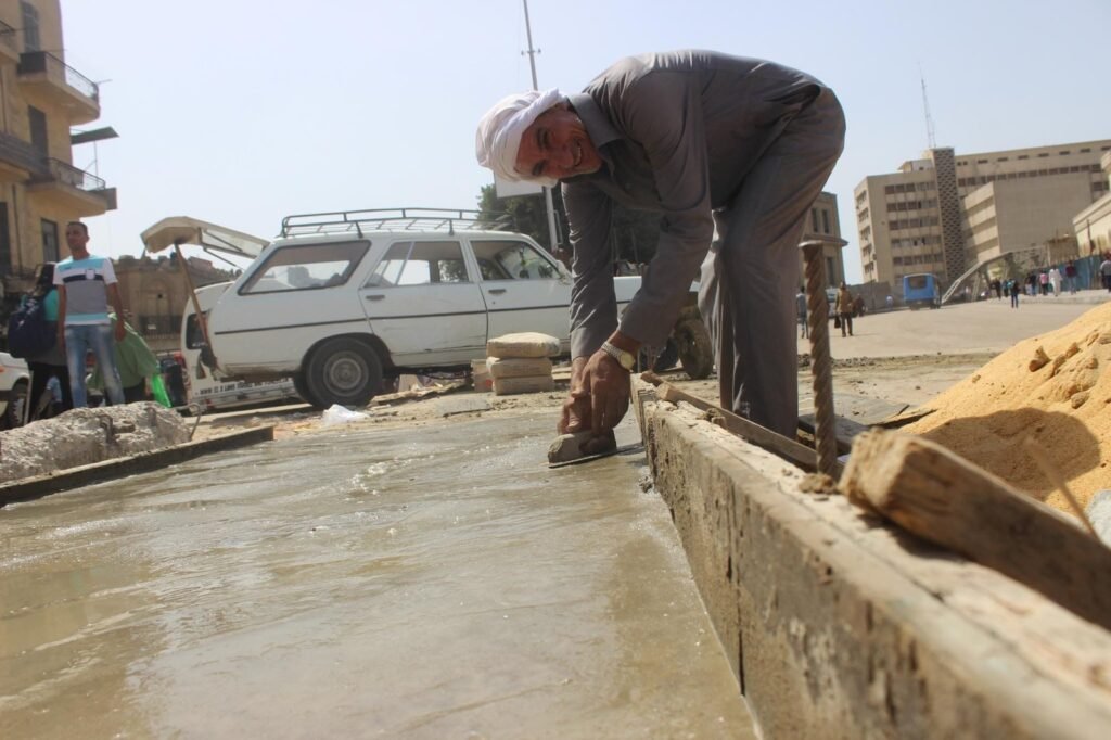 Cairo Street Worker Repairing Sidewalk Daylight Scene