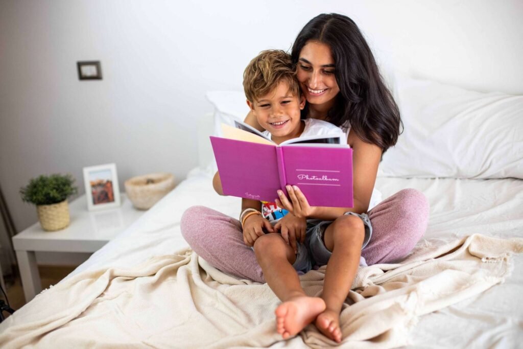 A girl is happily reading a book to her little brother