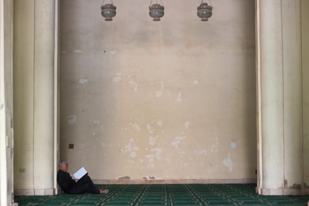 A man reads the Qur’an inside the historic Al-Hakim Mosque in Cairo.
