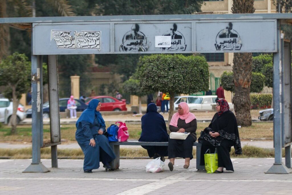 Women chatting at a bus stop in Cairo, Winter 2017